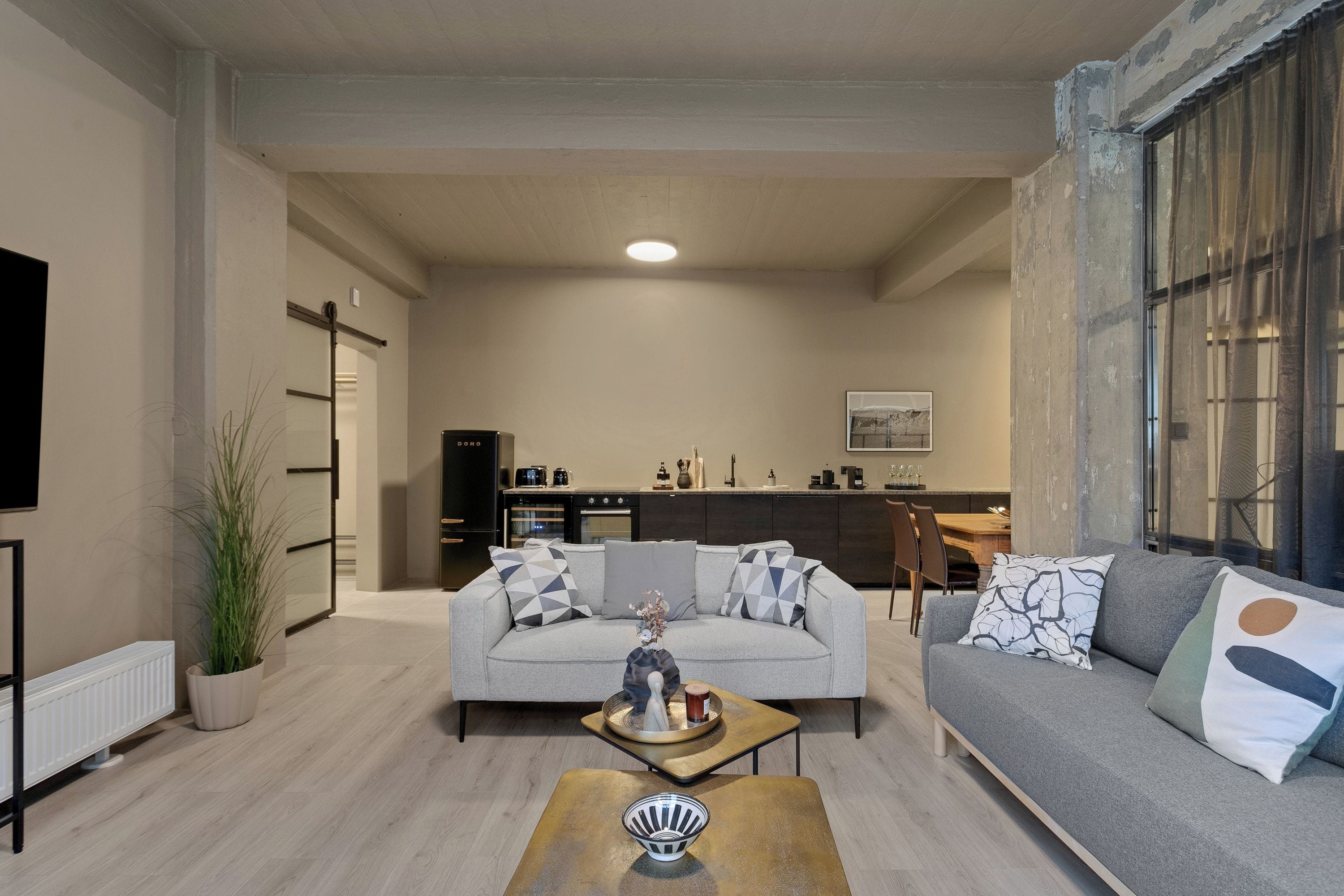 A modern living room with a sofa, coffee table, and a television.