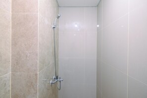 Deluxe Studio | Bathroom | Shower, free toiletries, towels - Simply And Nice Studio At Transpark Cibubur Apartment (Depok)