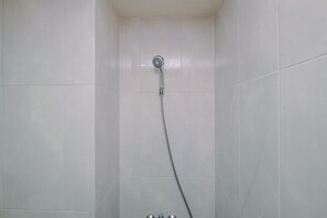 Deluxe Studio | Bathroom | Shower, free toiletries, towels - Comfy Studio At Evenciio Margonda Apartment (Depok)