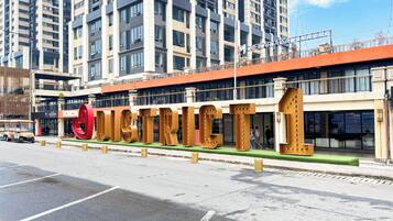 A modern building with large, metallic letters spelling "CITY" on the facade.