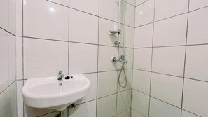 Deluxe Studio | Bathroom | Shower, free toiletries, towels - Warm And Comfy Studio Apartment (No Kitchen) Bandaraya - Tallasa City Makassar (Makassar)