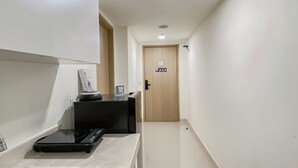 A modern kitchen with a built-in stove, a sink, and a countertop. - Simple 2BR at Meikarta Apartment (Cikarang)