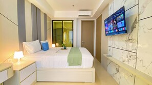 Relax in this stylish room with a comfortable bed, flat-screen TV, and sliding door to a city view balcony.