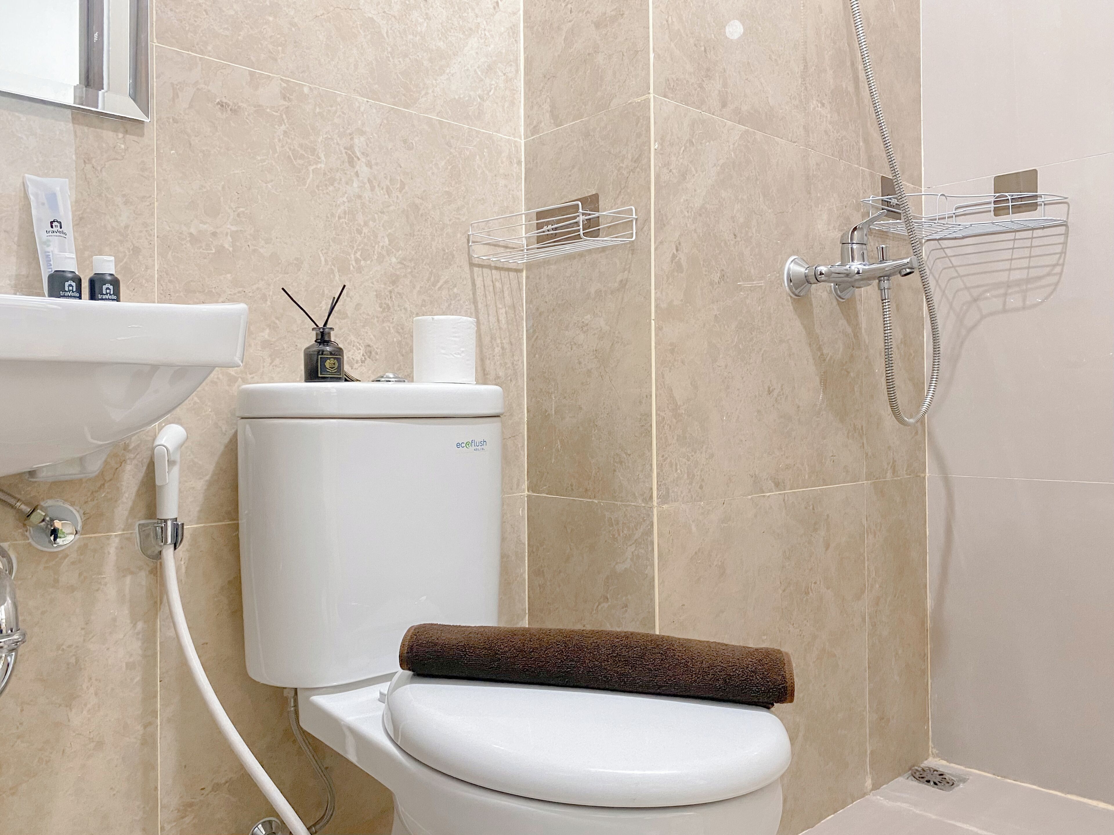 A bathroom with a toilet, sink, and shower.