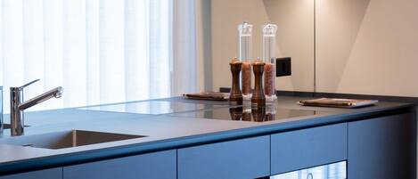 A modern kitchen with a large island, built-in appliances, and a sleek design.