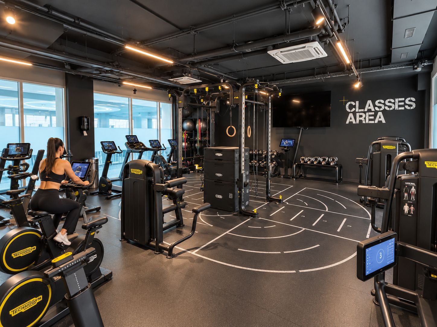 A gym with cardio equipment, weight machines, and a wall labeled 'CLASSES AREA'.
