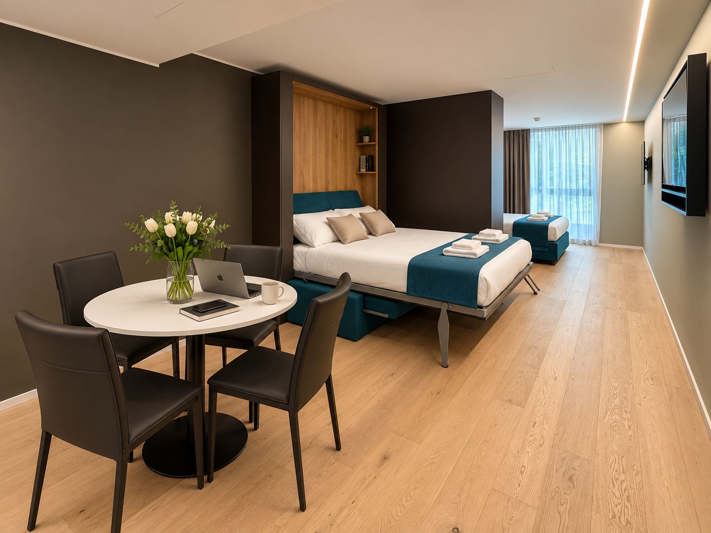 A modern hotel room with a bed, a desk, and a chair.