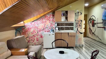 A compact kitchen with wooden cabinets, a white refrigerator, and a small countertop.