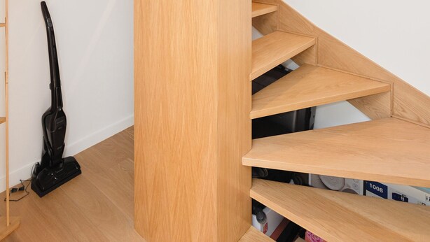 A modern staircase with wooden steps and a vacuum cleaner on the floor. - Colorwave Terrace House (Matosinhos)