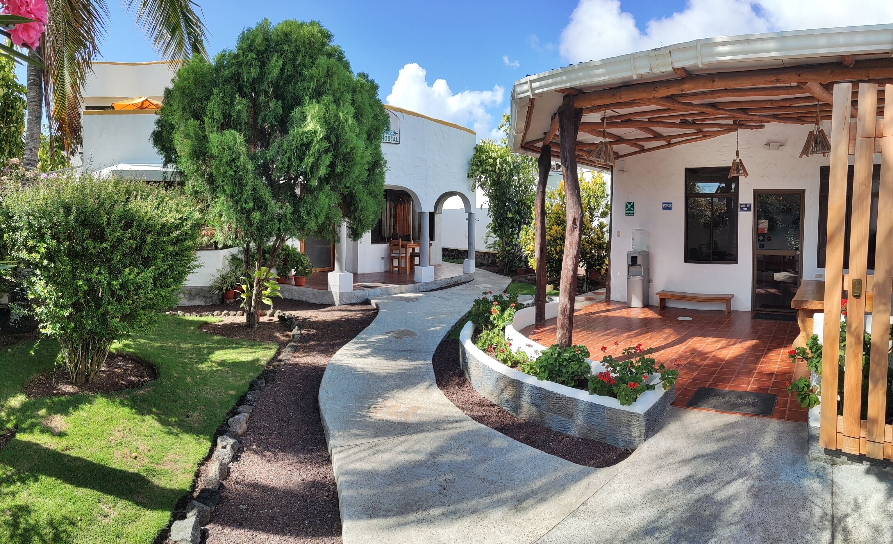 A courtyard with a covered seating area, a water dispenser, and a mailbox.
