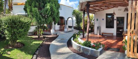 A courtyard with a covered seating area, a water dispenser, and a mailbox.