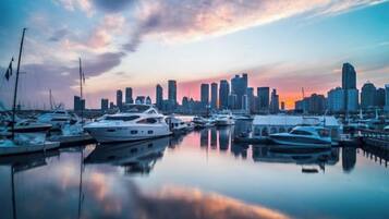 A marina with boats and a city skyline in the background.