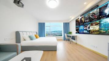 A modern hotel room with a large bed, a desk, and a wall-mounted TV.