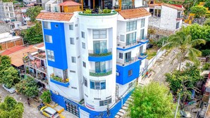 A multi-story building with balconies, a carport, and a visible entrance. - Romantic Zone newly renovated, super comfortable, one bedroom view condo (Puerto Vallarta)