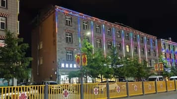 A multi-story building with a traditional architectural style, featuring a series of windows and a visible entrance.