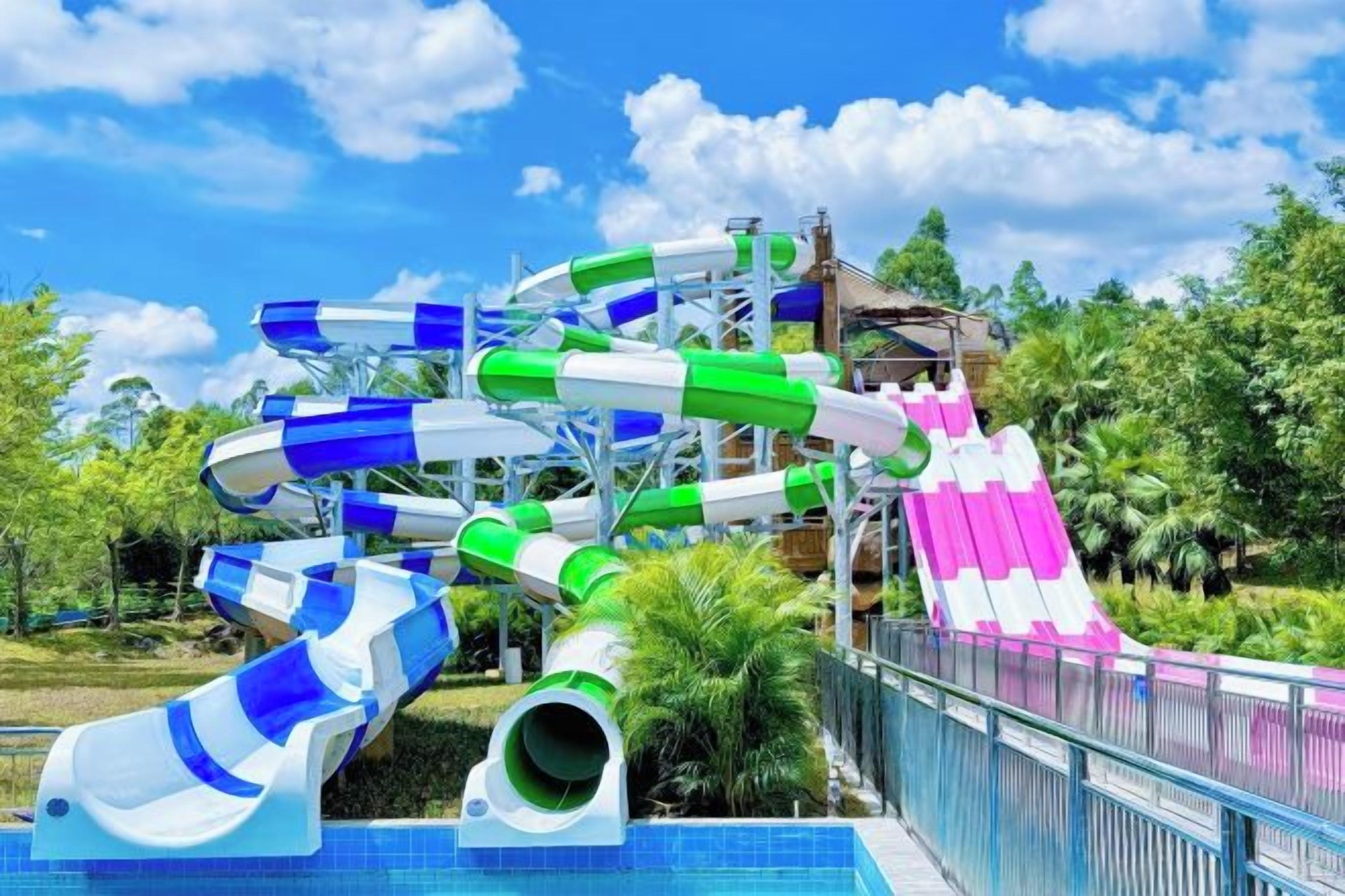 A water park with multiple water slides and a pool area.