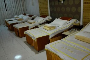 A row of single beds with white linens and brown headboards in a room with a tiled floor. - Yanduhe Hotel (Badong)