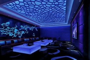 A modern lounge with a geometric ceiling design, seating areas, and a patterned floor. - Yanduhe Hotel (Badong)