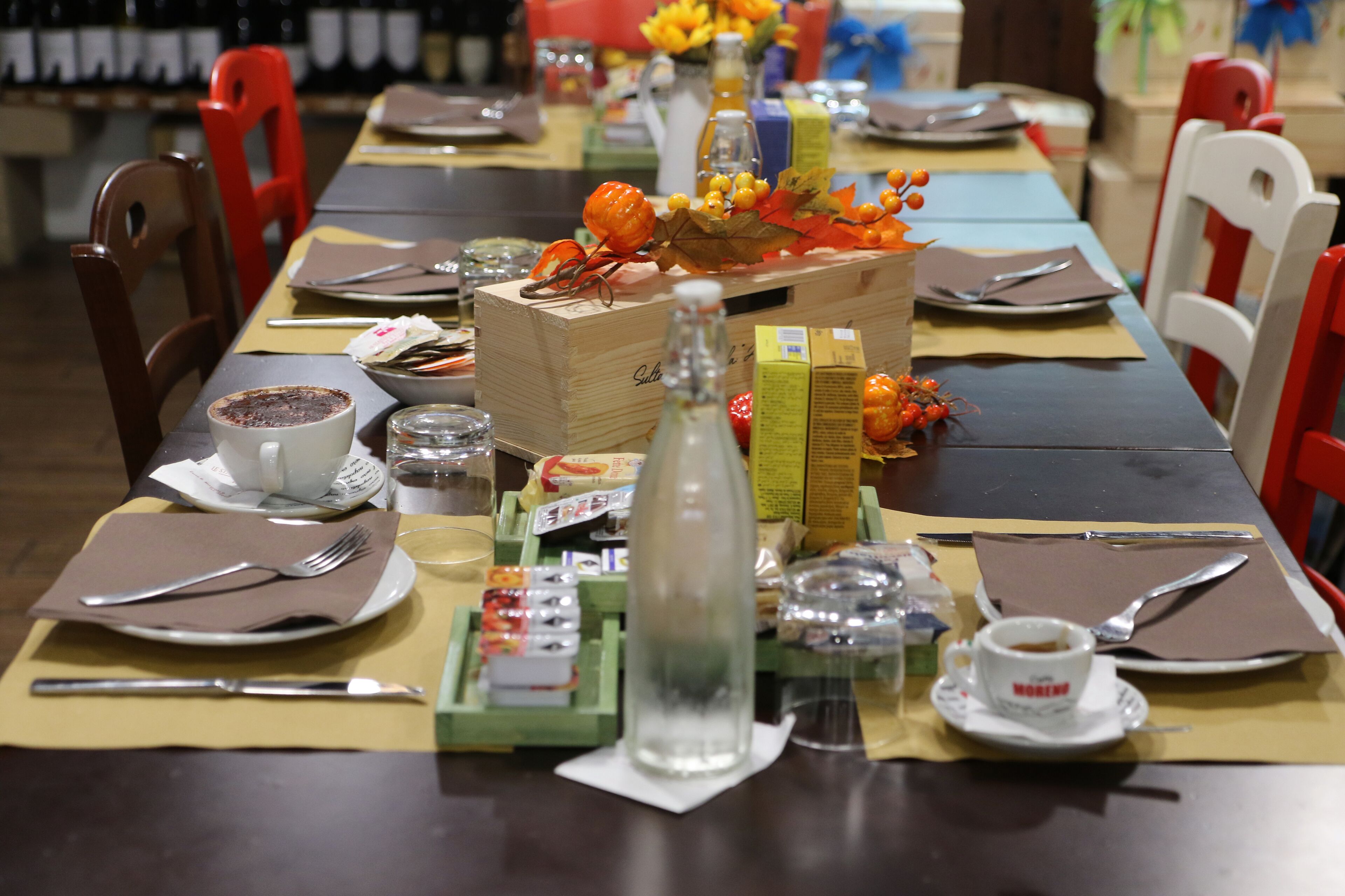 A dining table set with plates, cutlery, and various condiments.