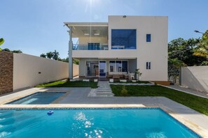 A modern two-story house with a swimming pool in the front yard. - Private Pool Retreat | 4BR | Sleeps 8 | POP (Puerto Plata)