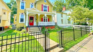 A two-story house with a porch, a red door, and a mailbox. - Historic Home within walking distance of Downtown Harmar & Marietta (Marietta)