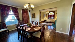 A dining area with a wooden table, chairs, and a chandelier. - Historic Home within walking distance of Downtown Harmar & Marietta (Marietta)