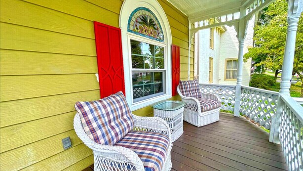 A porch with wicker furniture, a glass table, and a decorative window. - Historic Home within walking distance of Downtown Harmar & Marietta (Marietta)