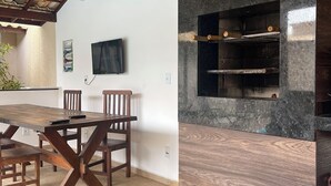 Una cucina moderna con forno integrato e zona pranzo con tavolo e sedie in legno.