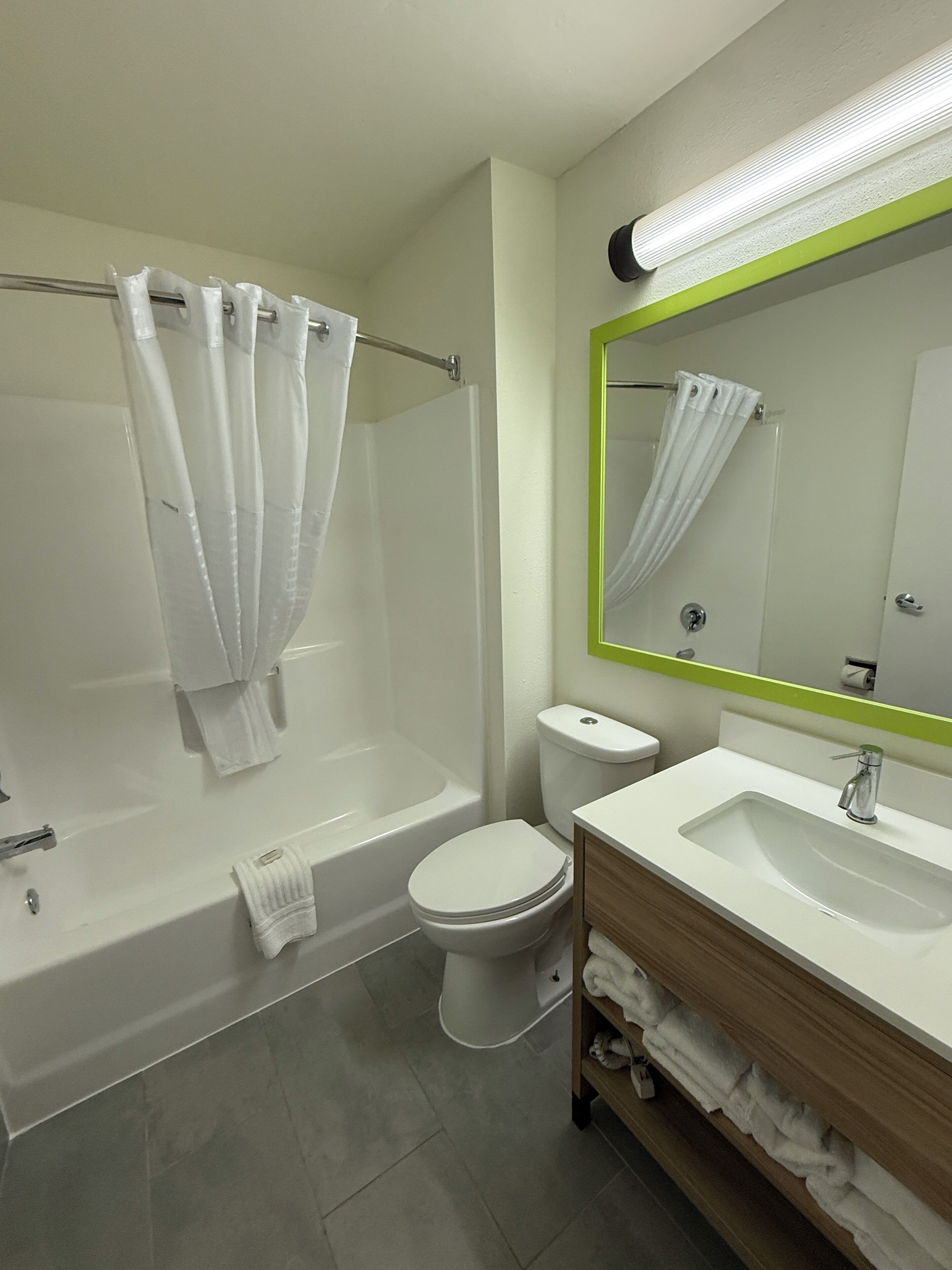 A modern bathroom with a bathtub, toilet, and sink.