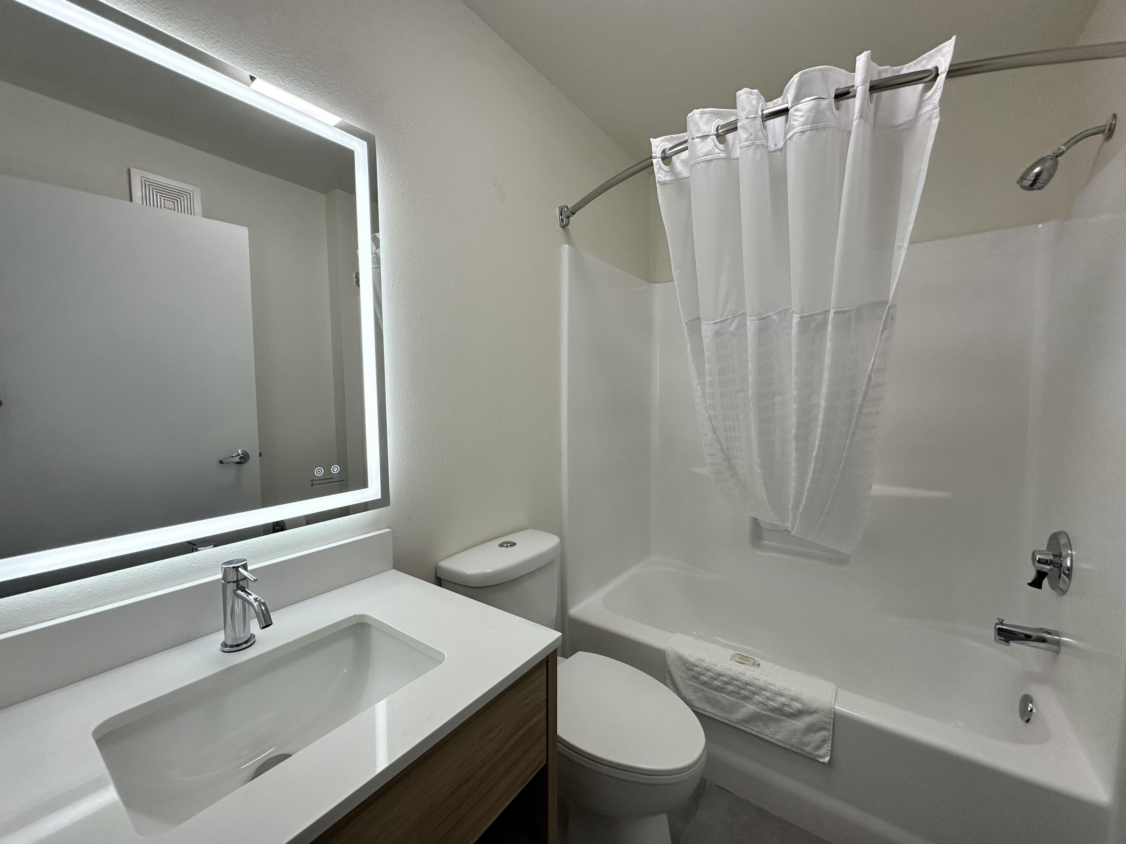 A bathroom with a sink, toilet, and bathtub.