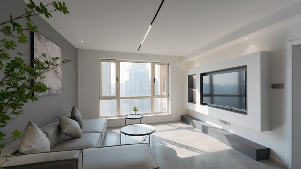 A modern living room with a sofa, a round table, a large window, and a TV mounted on the wall. - Eastern Hub - Brand New Apartment, Walk to People Square, Bund, Yuyuan Garden (Shanghai,)