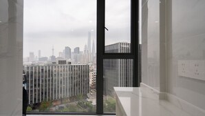 A modern interior with a large window overlooking a cityscape.