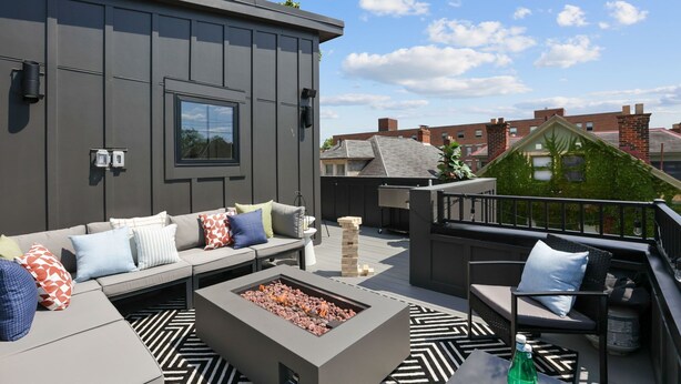 A rooftop patio with a fire pit, outdoor seating, and a view of neighboring buildings. - Rooftop Deck, Hot Tub, Speakeasy, Columbus Luxury (Columbus)