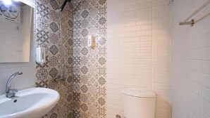 Un bagno con una tenda da doccia decorata, un lavandino bianco e un water.
