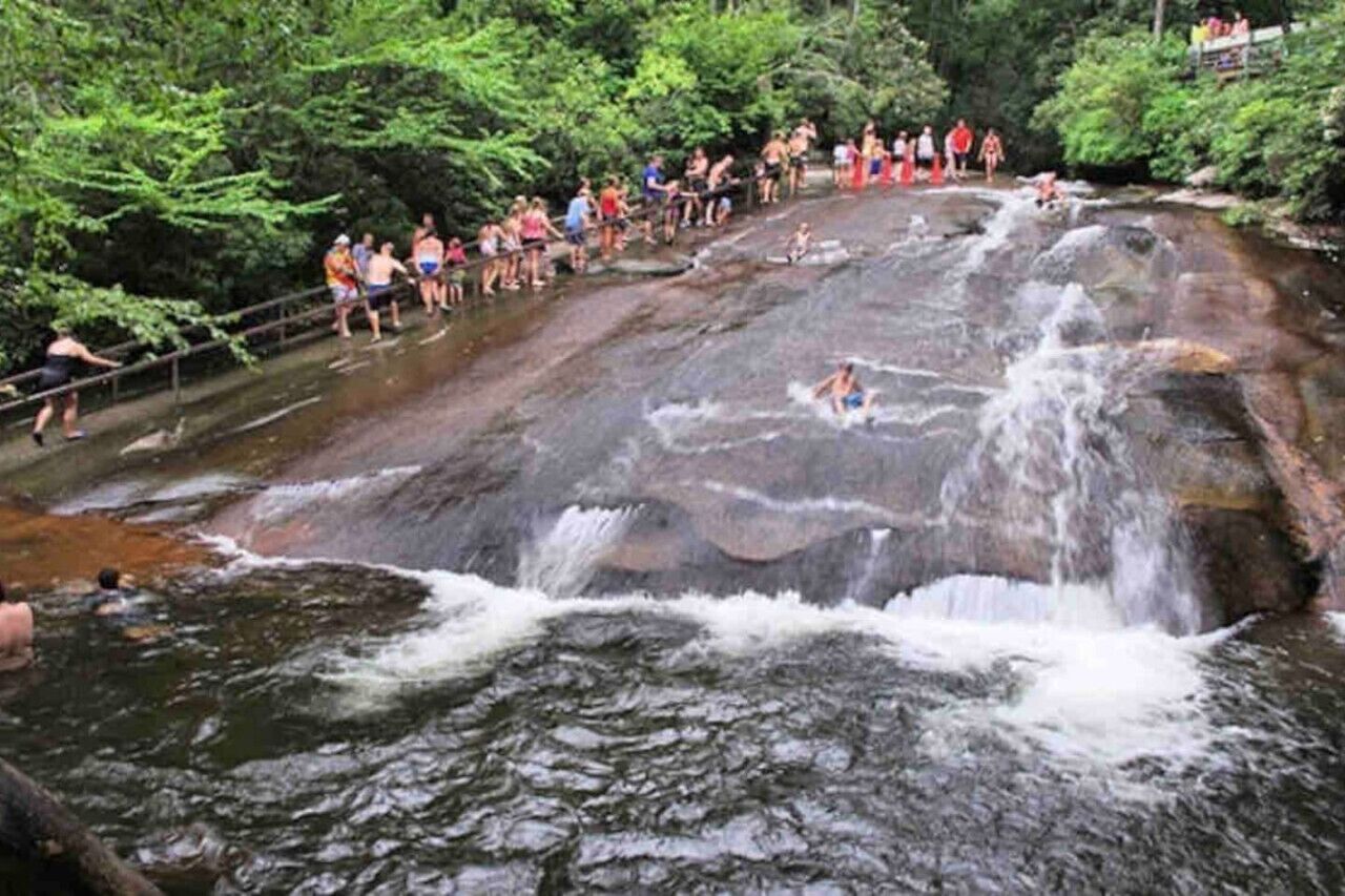 A waterfall with people standing on a viewing platform.