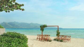On the beach, white sand, sun-loungers, beach umbrellas