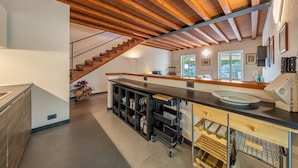 A modern kitchen with a wooden ceiling, a built-in bar area, and a staircase leading to another level. - VILLA DUFOUR 2 - Luxury, Swimming Pool, and Dream View (Zoagli)