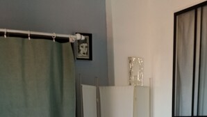 A bedroom with two beds, a wardrobe, a mirror, and a window with curtains. - Renovated fisherman's cottage  (Sète)