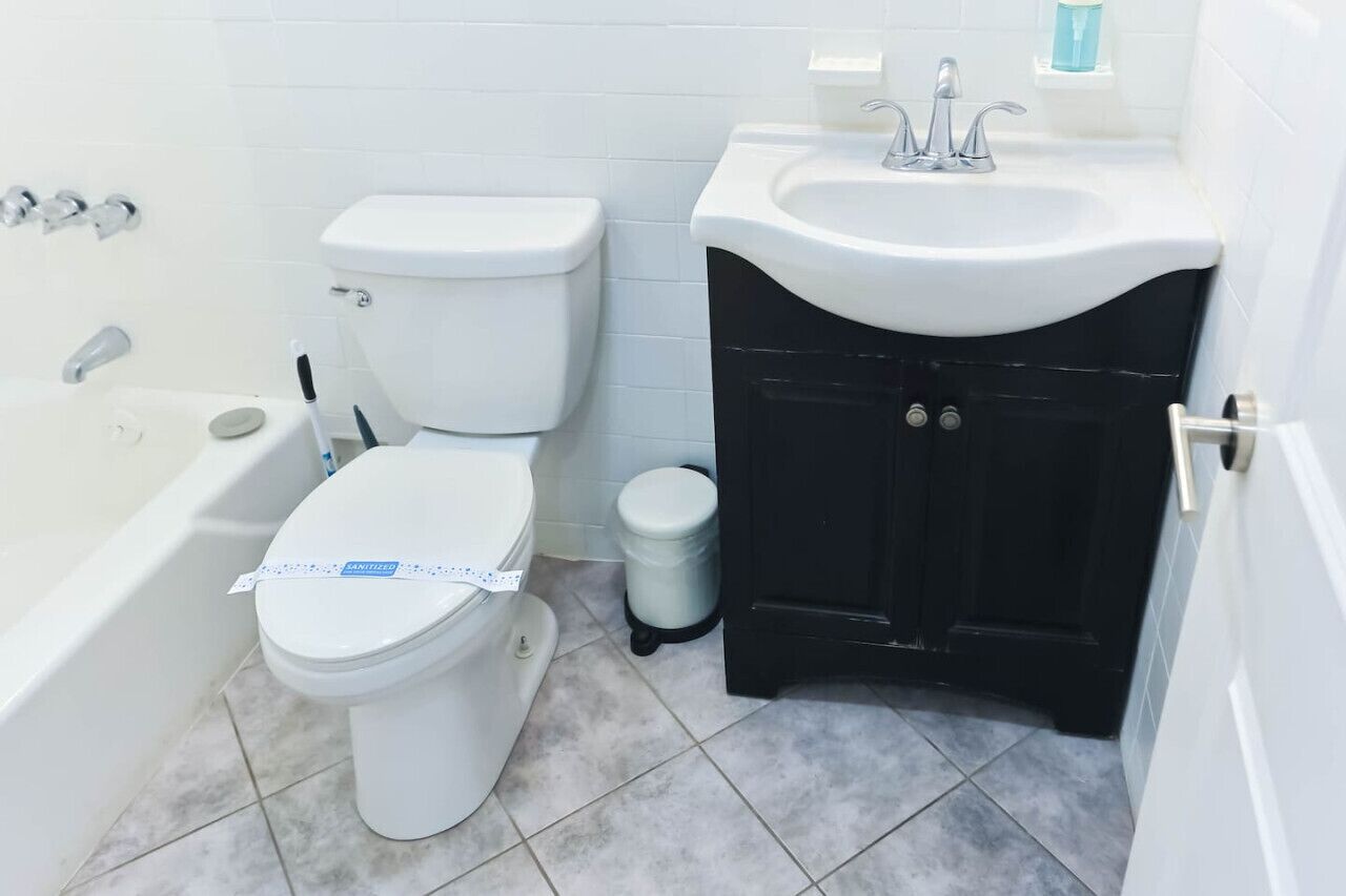 A bathroom with a toilet, a sink, and a bathtub.