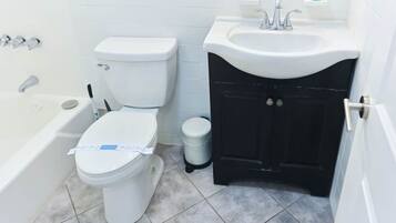 A bathroom with a toilet, a sink, and a bathtub.