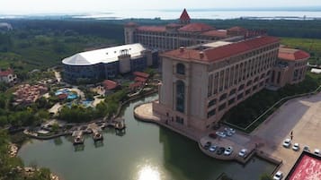 A large hotel with a central building, a waterfront, and a small island with docks.