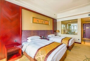 A hotel room with two beds, a large window, and a painting on the wall. - Hengshui Taihua Boyue Hotel (Hengshui)