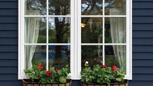 A window with a white frame and two flower boxes below it. - Charming 2-bedroom farmhouse with WiFi and AC in fabulous Bloomington (Bloomington)