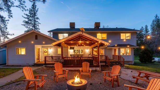A house with a covered patio, outdoor seating, and a fire pit. - Pool*Sauna*HotTub*Theater*Bar*Pickleball*Volleyball (Oakhurst)