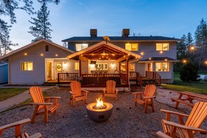 A house with a covered patio, outdoor seating, and a fire pit.