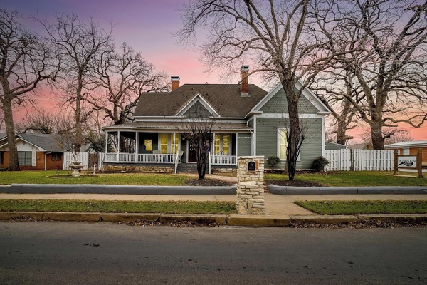 The beautifully restored Gallery House showcases its timeless architecture and inviting front porch