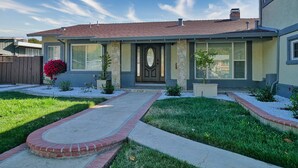 A two-story house with a stone facade, a red-tiled roof, and a front porch. - 4 Bd 4 Ba w/ Private Studio 10 G WIFI and AC (Hayward)