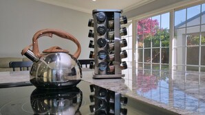 A kitchen with a kettle and a spice rack on a reflective countertop. - 4 Bd 4 Ba w/ Private Studio 10 G WIFI and AC (Hayward)