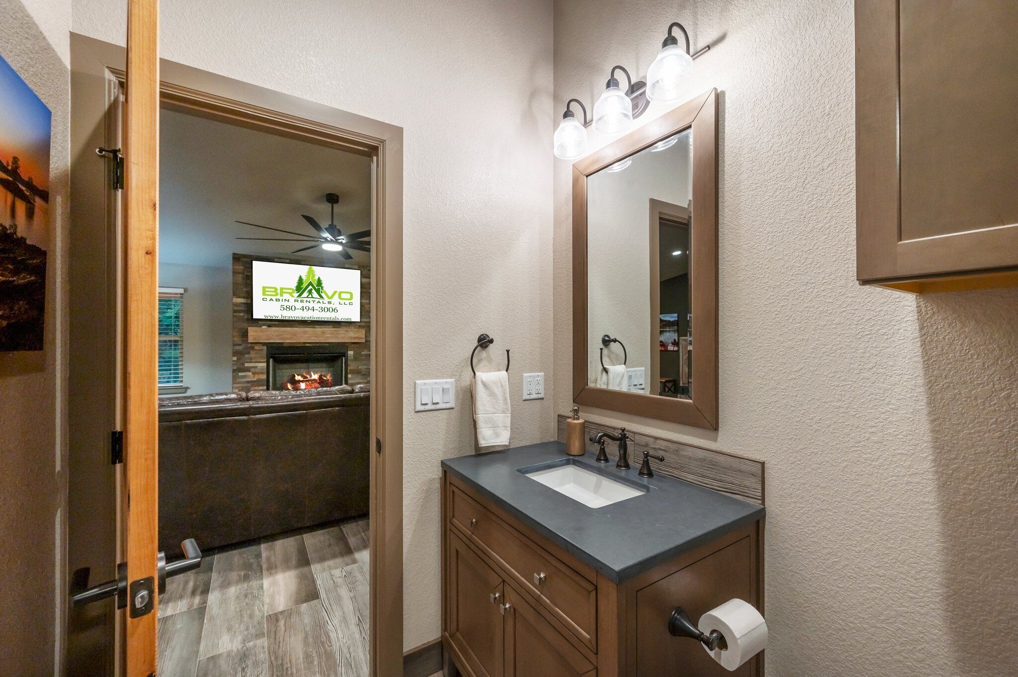 A bathroom with a sink, mirror, and towel rack.