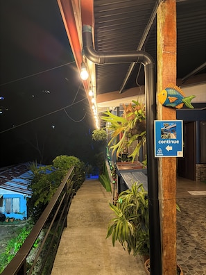 A pathway leading to a building with a sign indicating a continuation of the path.